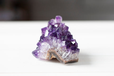 A dark purple amethyst cluster from Uruguay. Amethyst is thought to connect us to the divine realm.