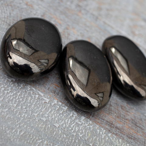 Smooth and sleek, this stone’s classic beauty lies in its simplicity. Jet Palm Stones by Cape Cod Crystals.