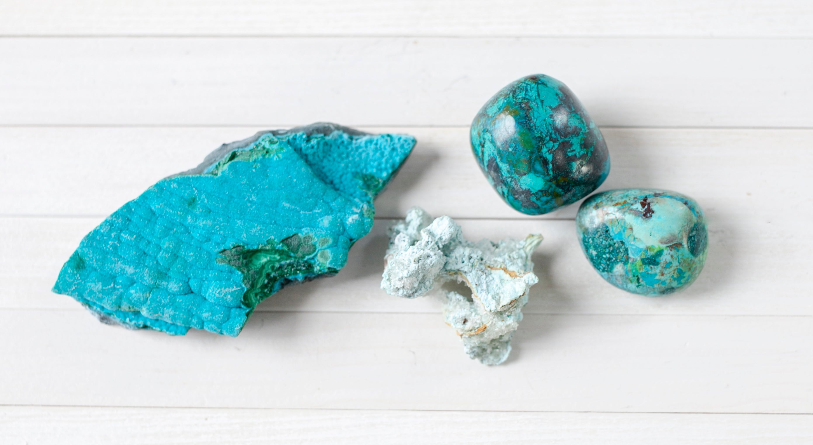 Raw and tumbled Chrysocolla. Chrysocolla is a unique mineral with vibrant teal color.